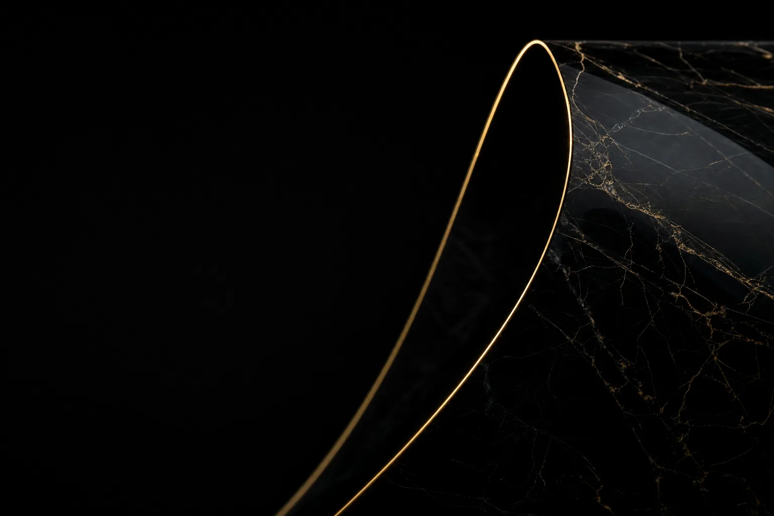 A sheet of black obsidian bent into a smooth arc with a razor-thin gold edge